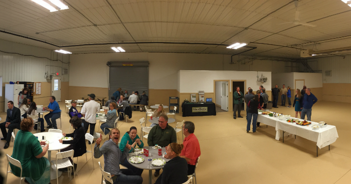The crowd mingling and eating during the Grand Opening